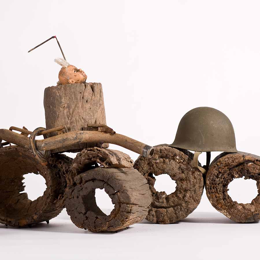 <strong>Gérard Quenum</strong>, <em>Dictateur</em> (detail), 2012.
Wood, doll, antenna, metal pipe and helmets, 78 x 105 x 637 cm